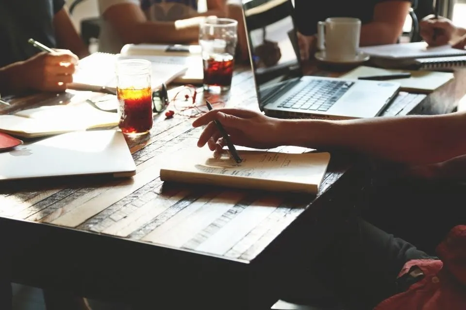 Team working together around a table with laptops