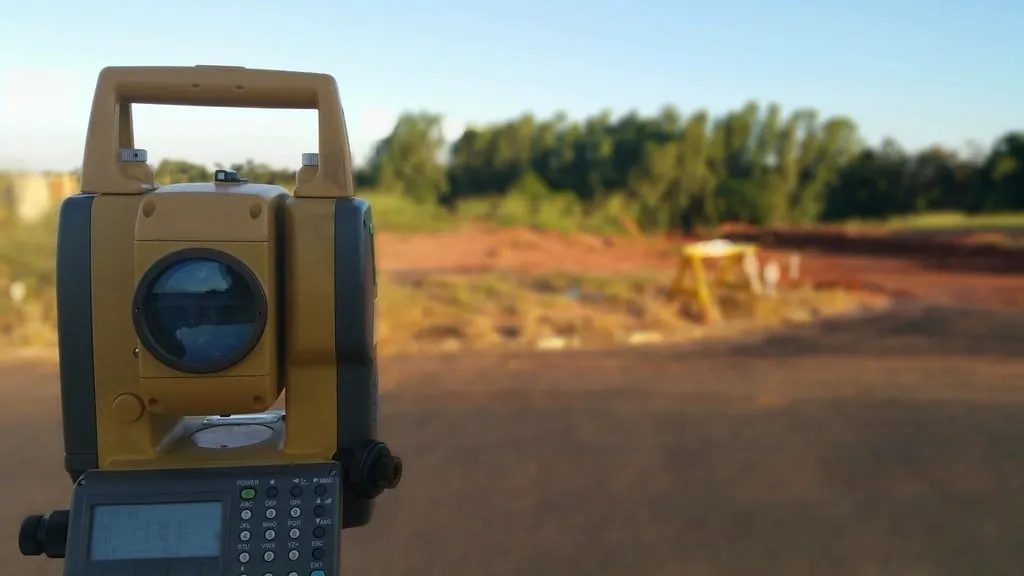 Total station surveying instrument set up on a site